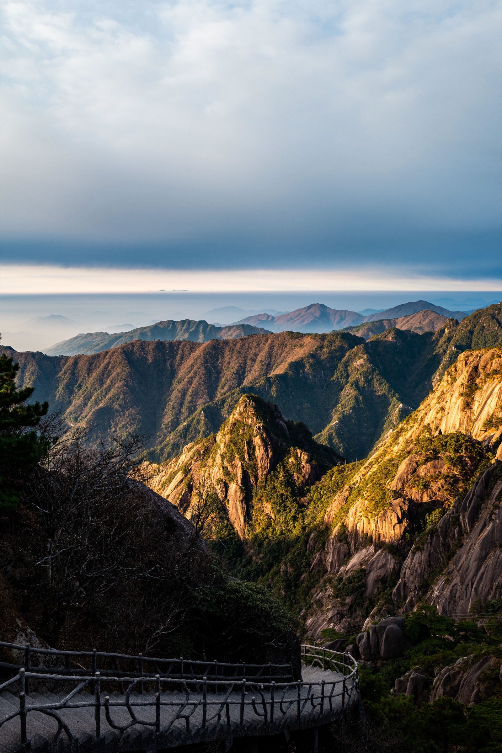 Layered mountain ridges under low cloud in Huangshan.